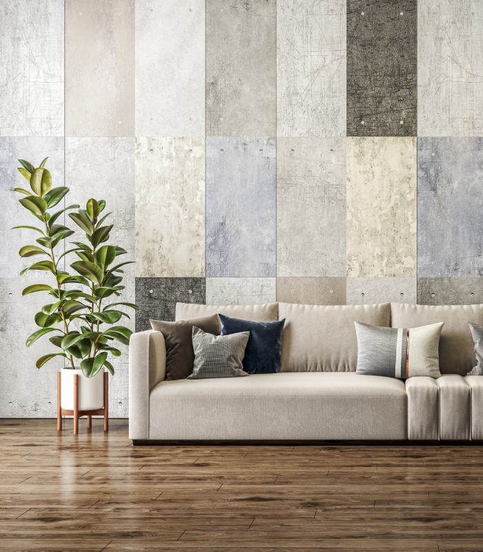 Mur intérieur avec carrelage décoratif effet béton derrière canapé de salon